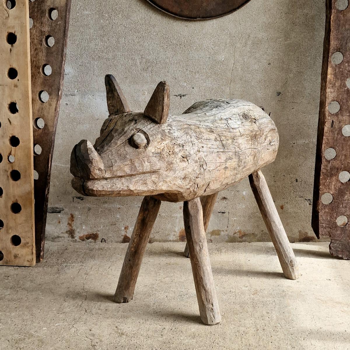 Life-size primitive pig sculpture