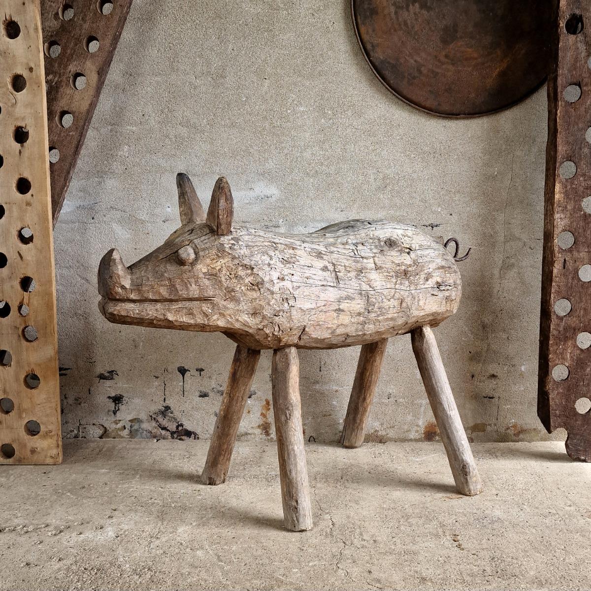 Life-size primitive pig sculpture