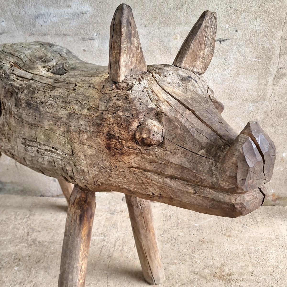 Life-size primitive pig sculpture