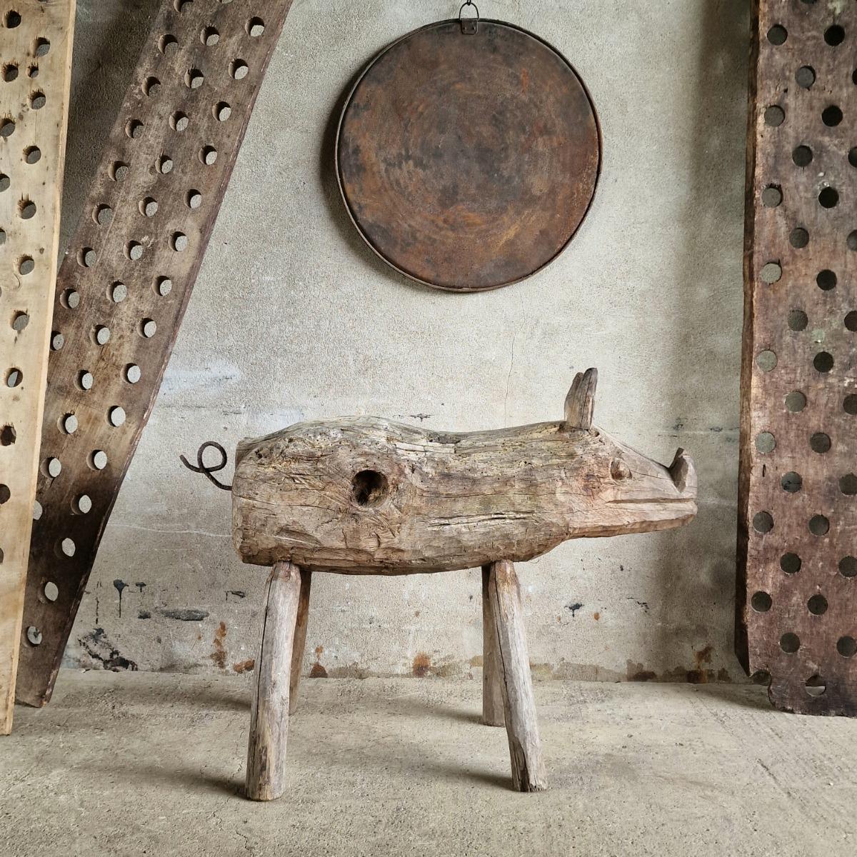 Life-size primitive pig sculpture