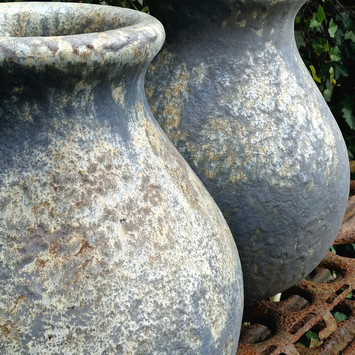 Pair of glazed terra cotta urns