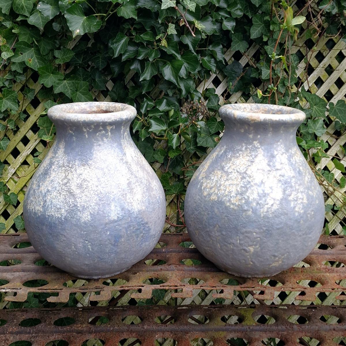 Pair of glazed terra cotta urns