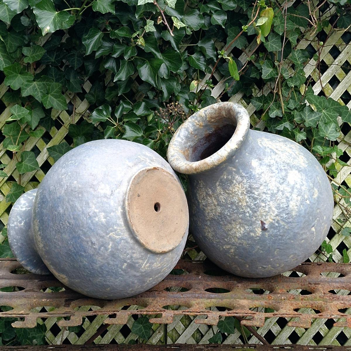 Pair of glazed terra cotta urns